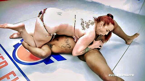 Bella Rossi in red bikini dominates black wrestler in mixed erotic grappling