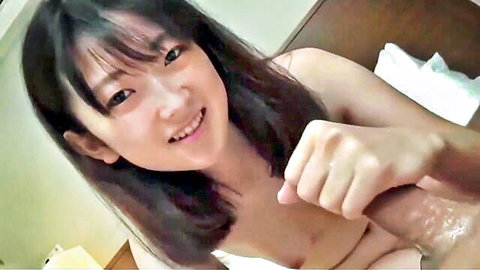 Japanese beauty smiling during handjob cumshot on hand and body