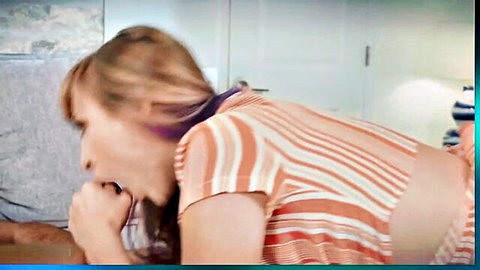 Chubby brunette in striped top bent over couch looking back