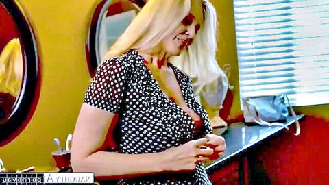 Blonde MILF teacher in low-cut polka dot dress teasing cleavage