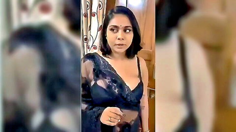 Fair-skinned slender busty woman in sheer black saree and lace bra
