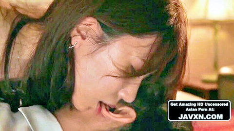 Beautiful Japanese MILF with long brown hair in intimate JAV close-up