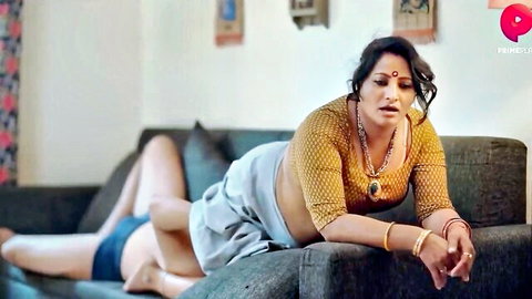 Curvy Indian housewife lounging seductively in yellow saree blouse