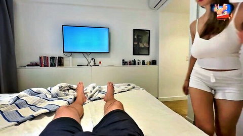 Curvy brunette in tight white shorts and tank top teases boyfriend on bed with sexy selfie