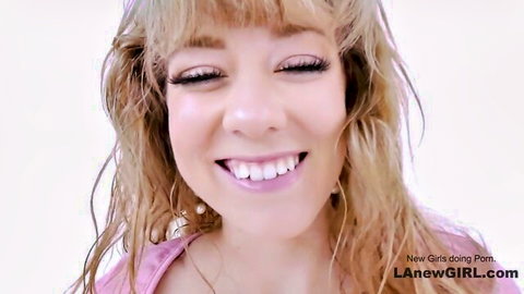 Steamy blonde teases with wet wavy hair in pink top