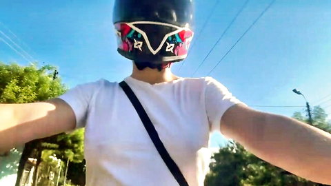 Busty Asian woman in helmet and white tee teases on outdoor ride, amateur POV