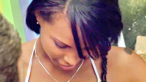 Ebony woman with braids in white top, outdoor vacation tease