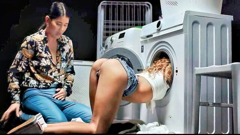 Blonde woman stuck in washing machine, brunette assists exposing big ass