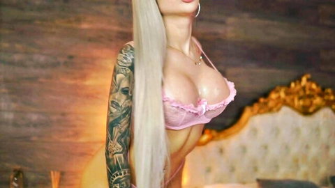 Juicy Jessye tattooed blonde in revealing pink lace bra, busty pose