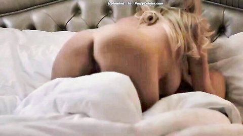 Blonde bombshell arching back nude on bed in hot couple sex scene