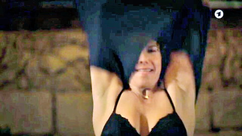 Brunette lifts black top over head exposing huge tits in sexy lace bra