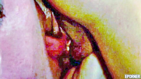 Extreme closeup of wet pink shaved pussy with spread labia and glistening clit.