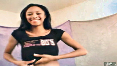 Smiling black babe in tight 'Girls in the 80s' top posing seductively