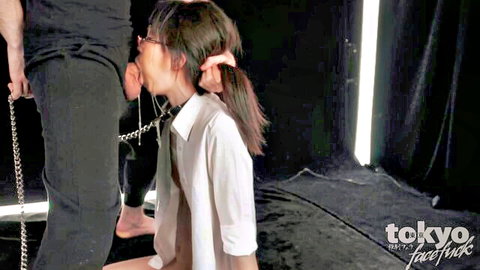 Asian woman in glasses kneels for intense facefuck with chain collar in Tokyo JAV scene