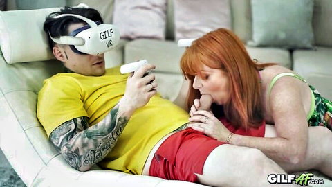 Redhead cougar giving intense blowjob to man in VR headset