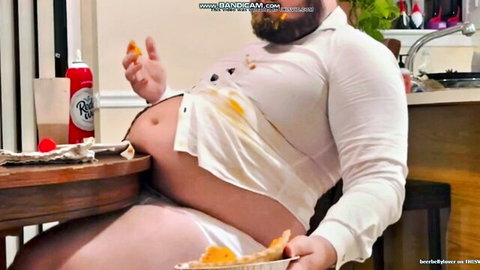 Bearded obese man in stained open shirt stuffing belly with pizza, gainer fetish solo
