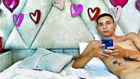 Zoelucas nude selfie on bed, young tattooed Latino man holding phone