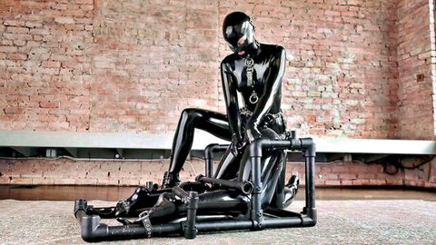 Latex-bound beauty in pile driver bondage pose