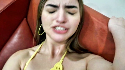 Julia James grimacing in ecstasy, wearing yellow bikini top in amateur POV tease