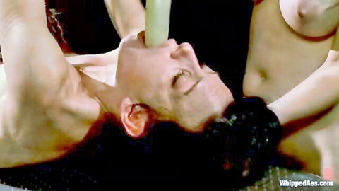 Cute brunette submissive dominated by two women with strap-on oral
