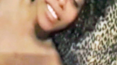Smiling Afro ebony babe topless with curly hair on leopard print