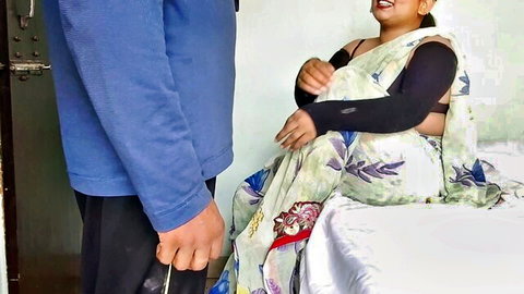 Smiling Indian MILF in saree gazes at man's crotch bulge while sitting on bed teasing blowjob