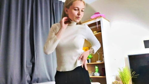 Blonde teen webcam model in tight white turtleneck sweater teasing by touching neck and hips