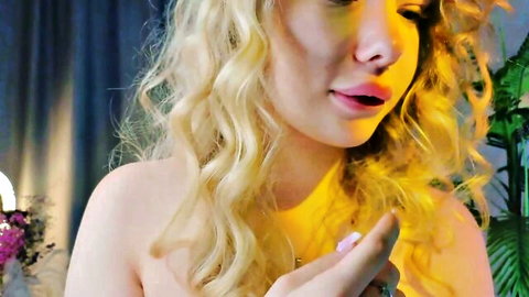 Blonde webcam girl puckers glossy pink lips topless teasing closeup