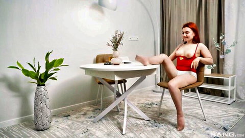 Fessa Lux caresses shaved pussy in red lingerie, solo redhead tease