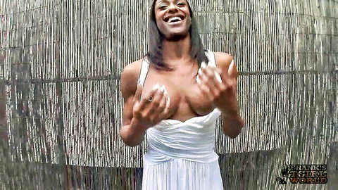 Athletic muscular black transsexual in white dress cupping breasts seductively