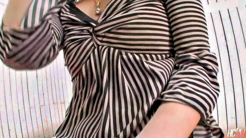 Sexy East Asian MILF in tight striped blouse showing deep cleavage and necklace