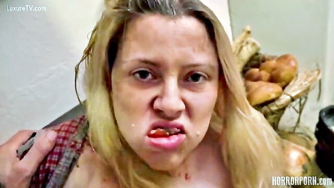 Blonde BBW grimaces with tongue out and drool topless in open plaid shirt amid corn in horror porn