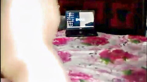 Desi couple relaxing on bed with laptop, intimate amateur setup