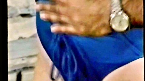 Ron Jeremy's hand groping curvy woman in blue bikini bottoms classic porn