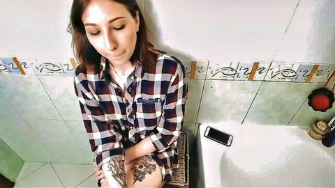 Brunette step-sister in plaid shirt teases in bathroom after catching brother