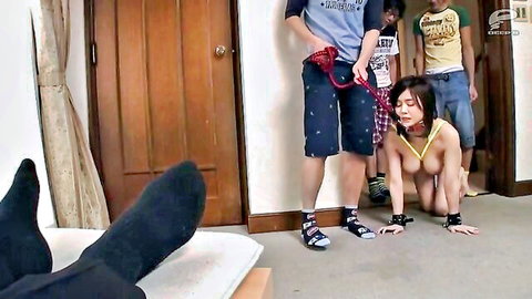 Naked Asian woman with big tits crawls on all fours leashed by two clothed guys in bedroom