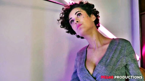 Charming cougar Victoria in low-cut gray dress, seductive gaze