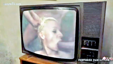 Blonde woman with wet hair deepthroats cock in closeup on old CRT TV screen.
