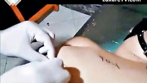 Masochist with sewn pussy touched by gloved hand underwater