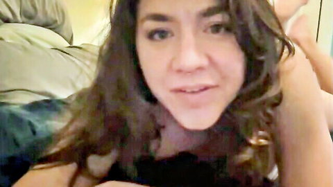Filipino webcam babe smiling seductively with deep cleavage in black top