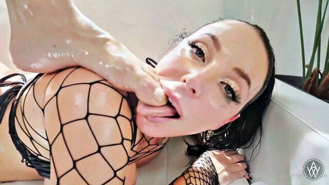 Angela White sucking her toes in wet fishnet lingerie solo