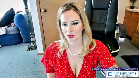 Busty blonde housewife teases deep cleavage in red polka dot top on Chaturbate webcam