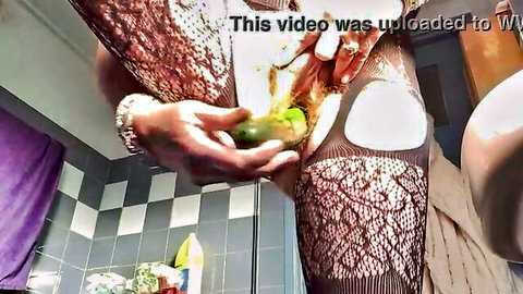 Granny in lace stockings teases shaved pussy with green avocado