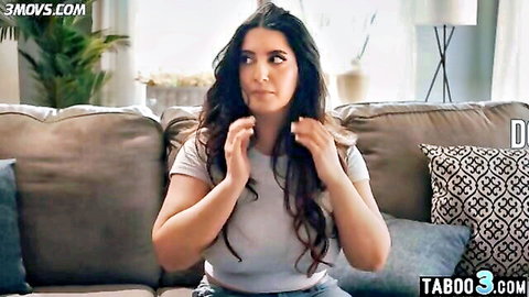 Arab MILF in white t-shirt looking concerned on couch
