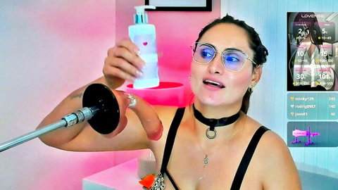 Latina cam girl with glasses and choker holds lotion teasing huge black dildo on fucking machine