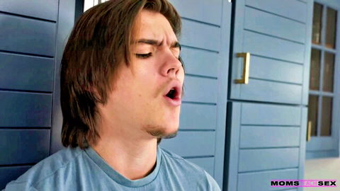 Young brunette guy with long hair moaning intensely mouth open against blue lockers in taboo Moms in Sex