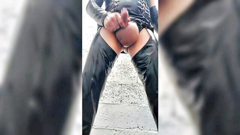 Latex-clad guy spreads ass cheeks fingering his tight pink anus outdoors