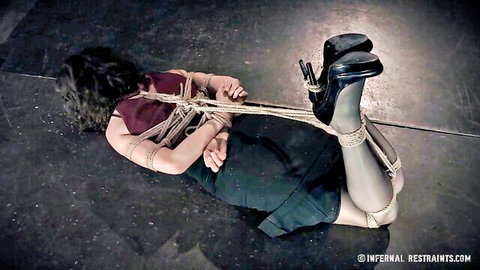 Bonnie Day bound in ropes, high heels and skirt in BDSM restraint scene