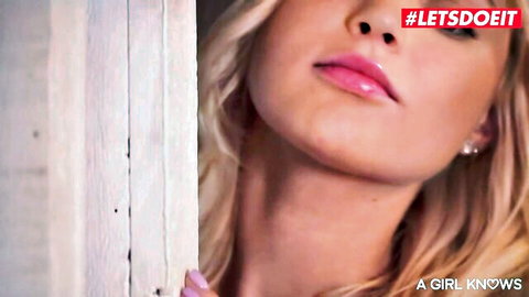 Seductive blonde with plump glossy lips peeking teasingly through door frame