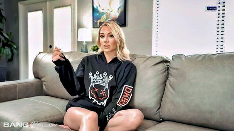 Blonde babe in oversized hoodie spreads legs teasing on couch